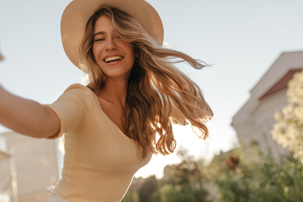 Does Hair Grow Faster In Summer article girl with hair and hat in the summer